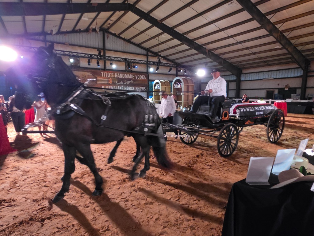 September 11 Friesian Horse Remembrance caisson procession carrying the We Will Never Forget memorial inside Queenslake Arena