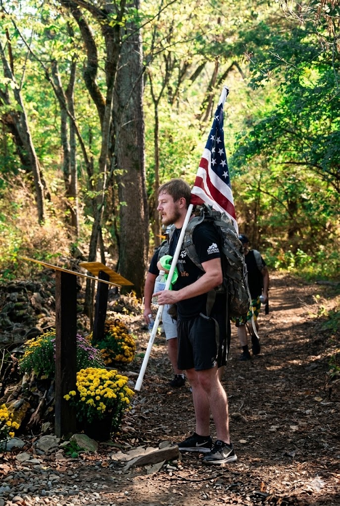 Athlete Paused in Reverence at Memorial Station
